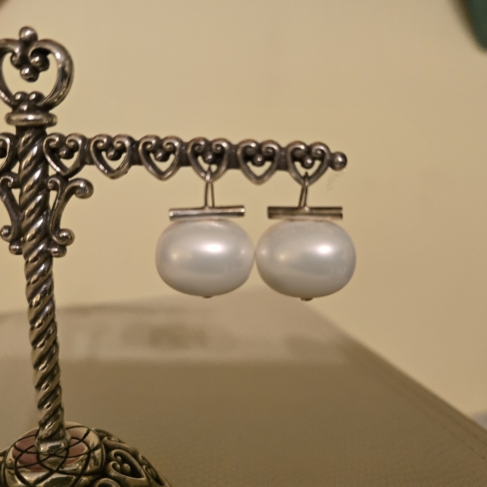 Contemporary large faux pearl wire drop earrings.